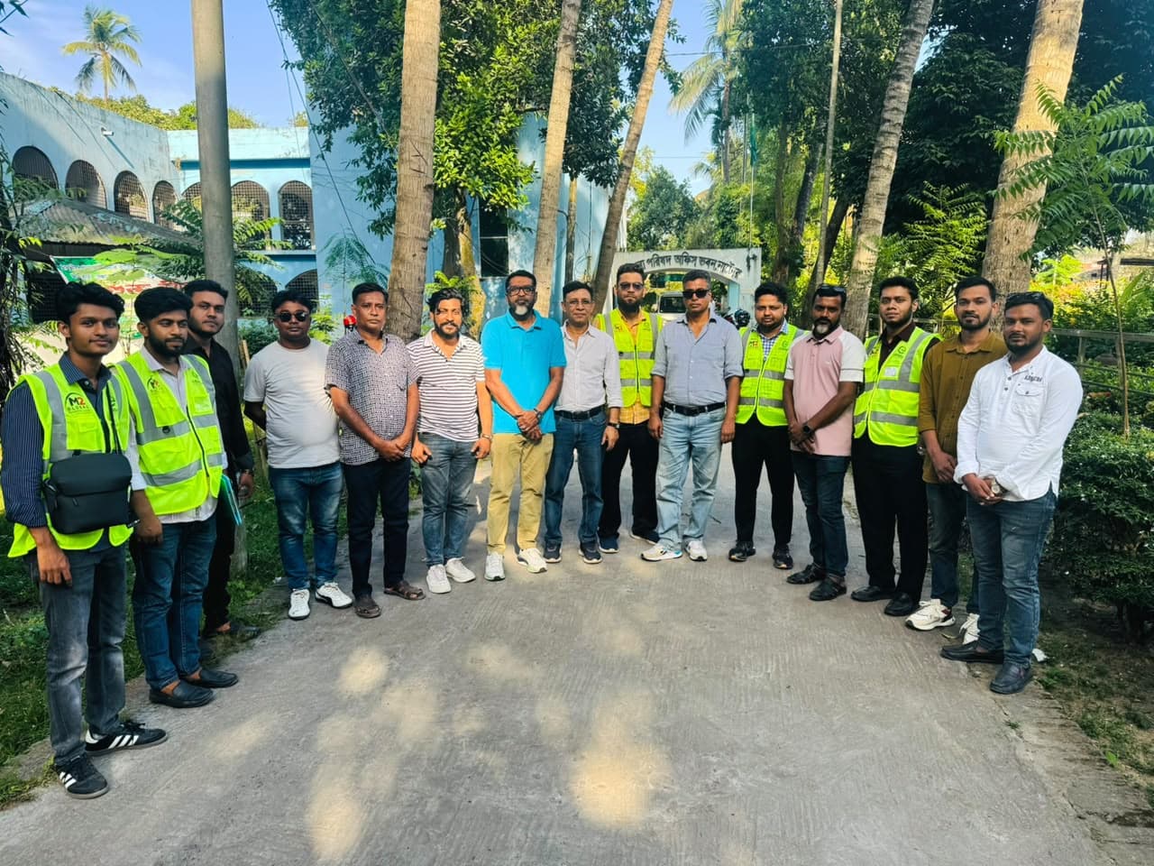 The eBiddut team standing together with local hosts in front of a government office in Natore